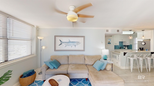 511 E Beach Blvd Unit 503, Gulf Shores, AL 36542 - living area with ceiling fan, baseboards, and crown molding
