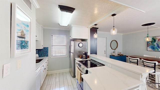 511 E Beach Blvd Unit 503, Gulf Shores, AL 36542 - kitchen with a peninsula, stainless steel appliances, white cabinets, ornamental molding, and backsplash