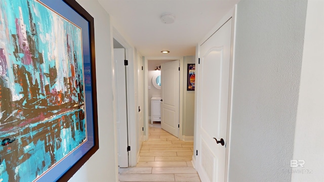 511 E Beach Blvd Unit 503, Gulf Shores, AL 36542 - corridor featuring stacked washer / dryer, recessed lighting, and wood tiled floors