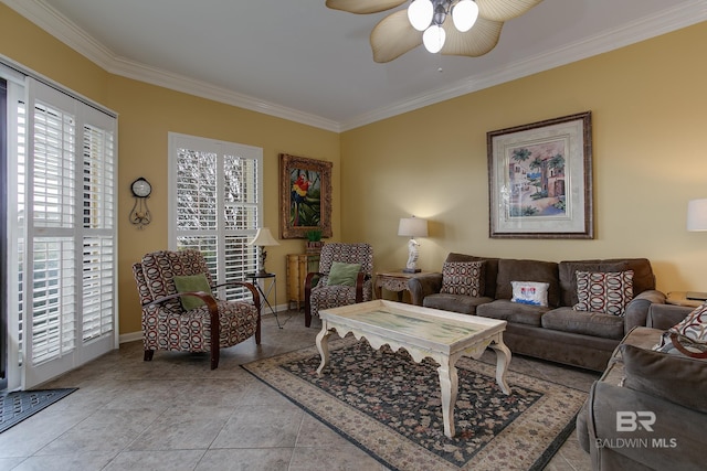 living room with ceiling fan, baseboards, ornamental molding, and light tile patterned floors