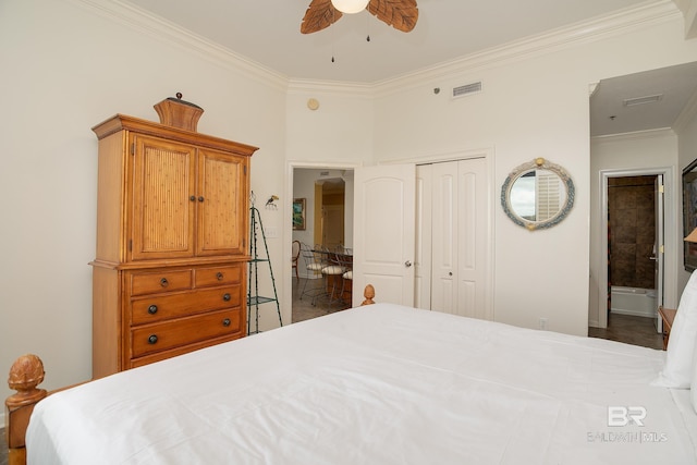 bedroom featuring visible vents, a ceiling fan, ensuite bath, a closet, and crown molding