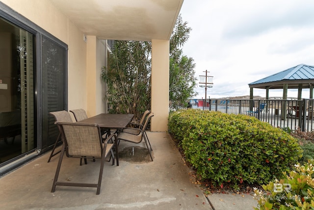 view of patio with outdoor dining space and fence