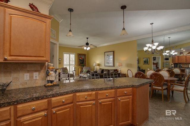 kitchen featuring decorative backsplash, a peninsula, open floor plan, and ornamental molding