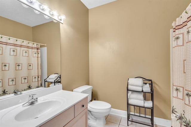 201 W 13th St Unit 2 B, Gulf Shores, AL 36542 - bathroom with tile patterned flooring, vanity, toilet, a shower with curtain, and baseboards