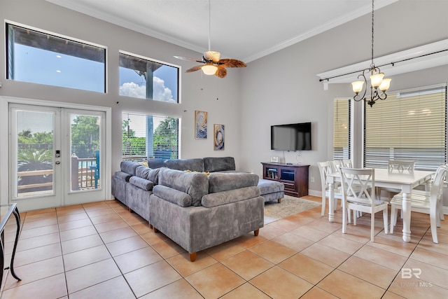 201 W 13th St Unit 2 B, Gulf Shores, AL 36542 - living area with light tile patterned floors, ornamental molding, a chandelier, a ceiling fan, and french doors