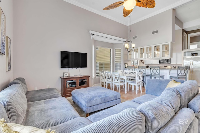 201 W 13th St Unit 2 B, Gulf Shores, AL 36542 - living area with a chandelier, a ceiling fan, crown molding, a high ceiling, and baseboards