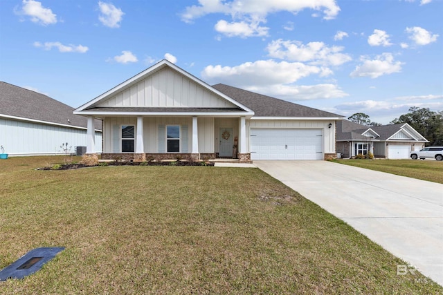 view of front of house with board and batten siding, a front yard, central AC, a garage, and driveway