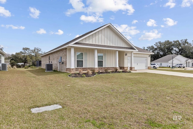 view of front of house featuring driveway, a garage, a front lawn, central AC, and brick siding