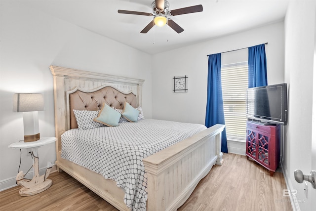 bedroom featuring ceiling fan, baseboards, and wood finished floors