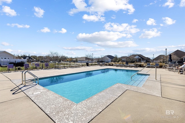 pool featuring a residential view, fence, and a patio