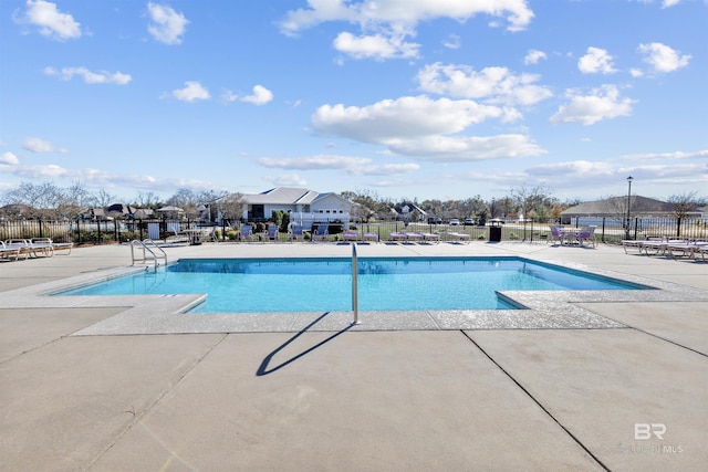 community pool featuring a patio area and fence