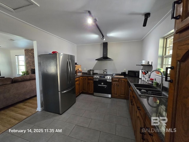 kitchen featuring wall chimney exhaust hood, tile patterned floors, sink, track lighting, and stainless steel appliances