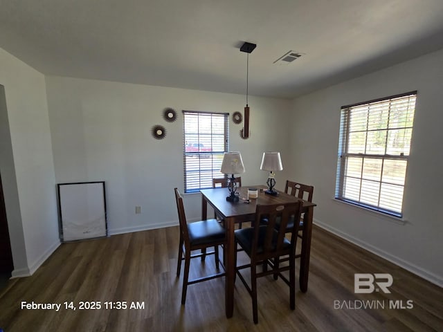 dining space featuring dark hardwood / wood-style flooring