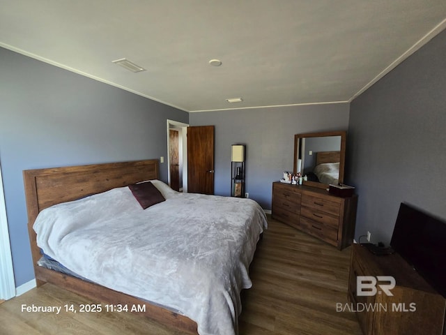 bedroom featuring crown molding and hardwood / wood-style flooring