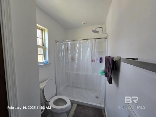 bathroom with toilet and walk in shower