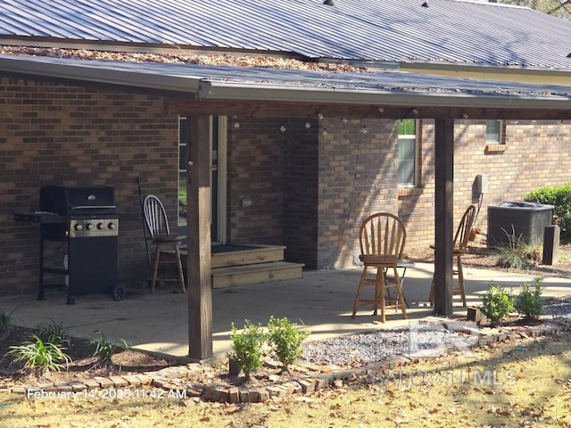 view of patio featuring a grill and central air condition unit