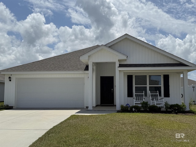 ranch-style home with roof with shingles, an attached garage, driveway, a front lawn, and a porch