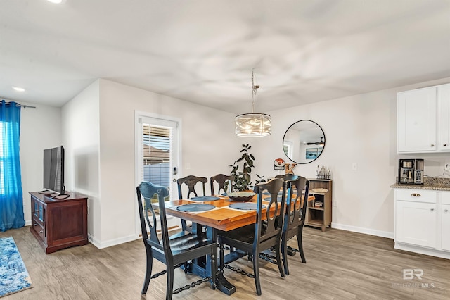 dining room with light wood-style floors and baseboards