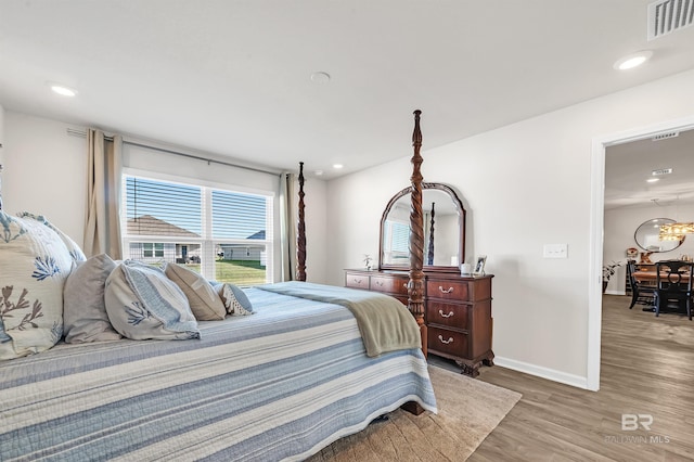 bedroom featuring wood finished floors, baseboards, and recessed lighting