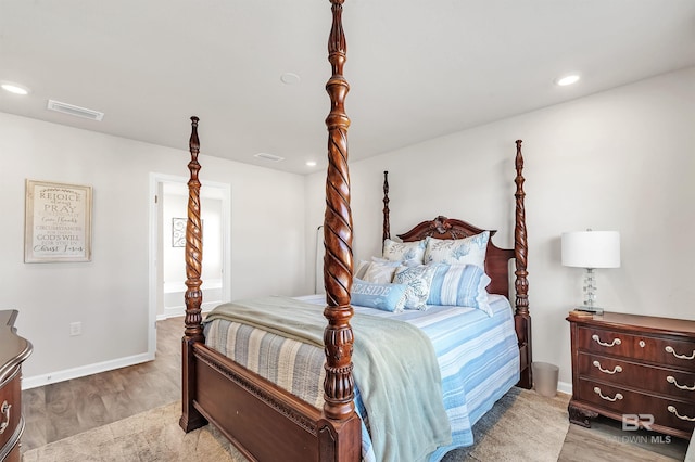 bedroom with light wood-style floors, baseboards, and recessed lighting