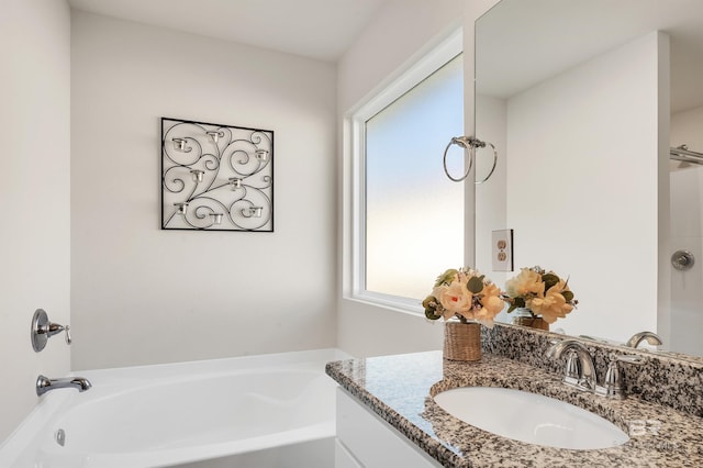 bathroom featuring a bath and vanity