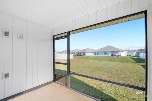 unfurnished sunroom featuring a residential view