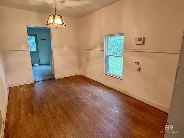 42186 Nicholsville Rd, Bay Minette, AL 36507 - empty room featuring dark wood-style flooring, a chandelier, plenty of natural light, and baseboards