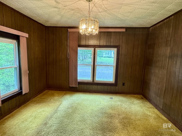 42186 Nicholsville Rd, Bay Minette, AL 36507 - spare room with light colored carpet, a chandelier, and wooden walls