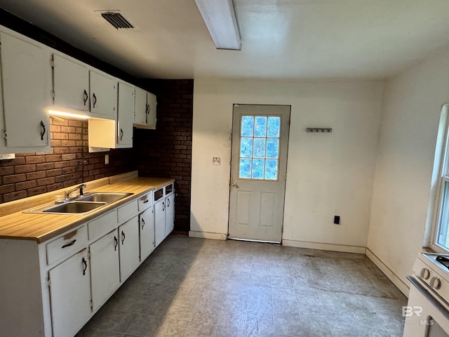 42186 Nicholsville Rd, Bay Minette, AL 36507 - kitchen featuring a sink, light countertops, white cabinets, and baseboards