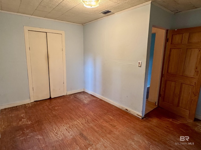 42186 Nicholsville Rd, Bay Minette, AL 36507 - unfurnished bedroom with wood finished floors, crown molding, baseboards, and a closet