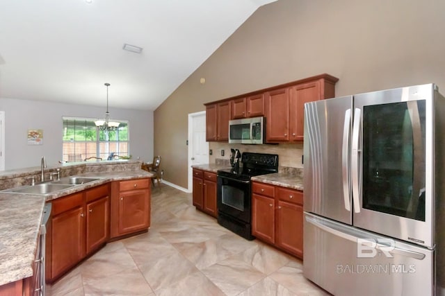 10234 Scott Plantation Dr, Mobile, AL 36695 - kitchen featuring appliances with stainless steel finishes, brown cabinets, a chandelier, pendant lighting, and high vaulted ceiling