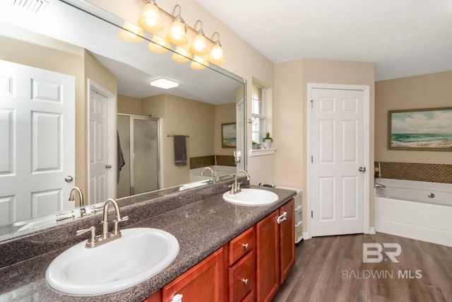 10234 Scott Plantation Dr, Mobile, AL 36695 - bathroom featuring a garden tub, wood finished floors, a shower stall, and double vanity
