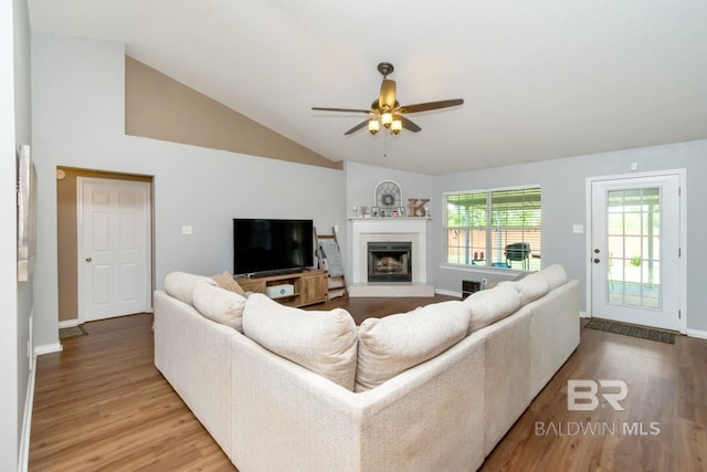10234 Scott Plantation Dr, Mobile, AL 36695 - living room featuring wood finished floors, vaulted ceiling, a ceiling fan, and a fireplace with raised hearth