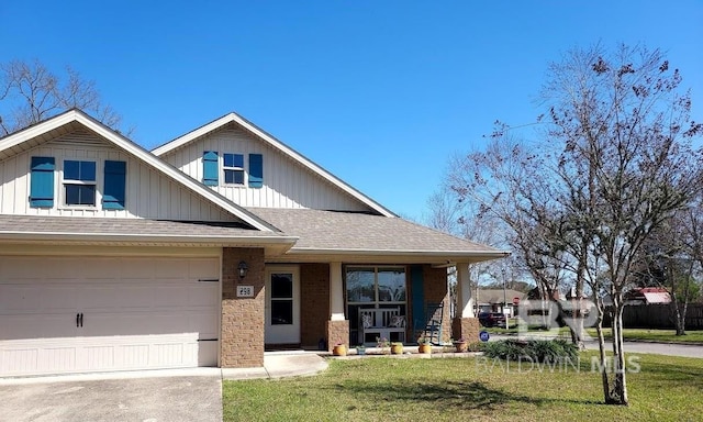 view of front of house featuring brick siding, a porch, a front yard, a garage, and driveway