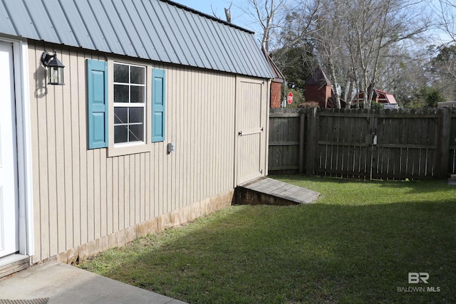 view of outbuilding with an outdoor structure and a fenced backyard