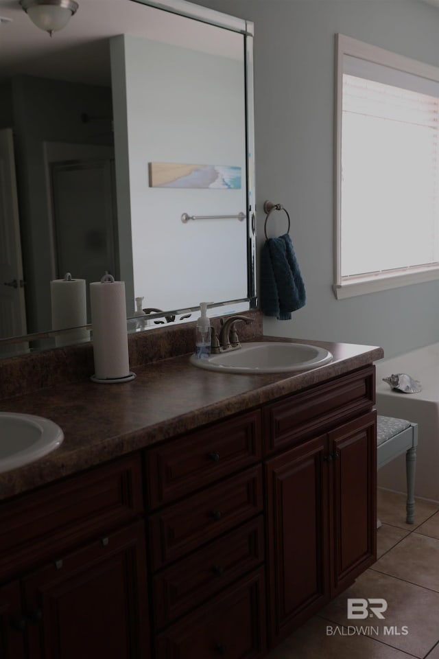 full bathroom with tile patterned flooring, double vanity, and a sink