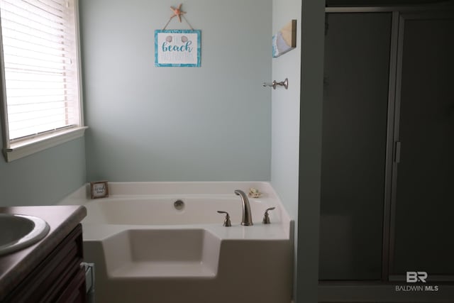 full bathroom with vanity and a garden tub