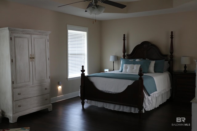 bedroom featuring baseboards, dark wood-style flooring, and ceiling fan