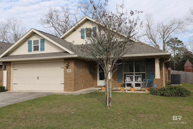 view of front of home featuring a front yard, a porch, concrete driveway, a garage, and brick siding