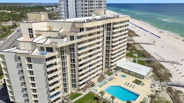 drone / aerial view with a water view and a beach view