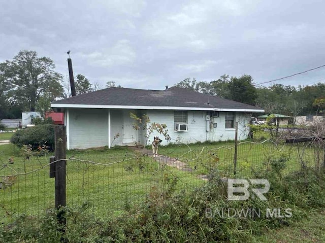 rear view of property featuring cooling unit and a yard