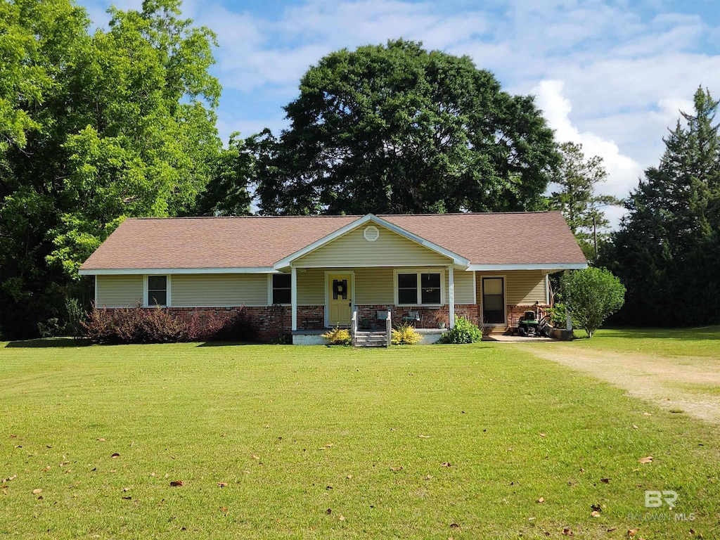 571 Georgia Ln, Brewton, AL 36426 - view of front of home featuring covered porch, a front lawn, and driveway