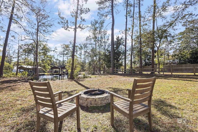 view of yard with fence and a fire pit