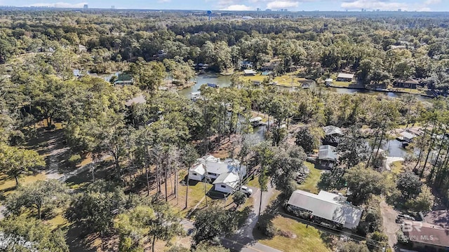 aerial view with a water view and a wooded view