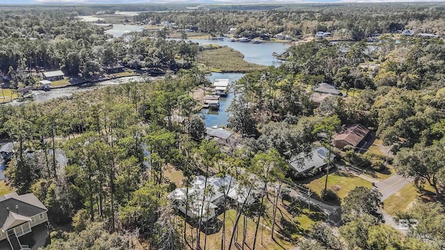 drone / aerial view featuring a water view and a wooded view