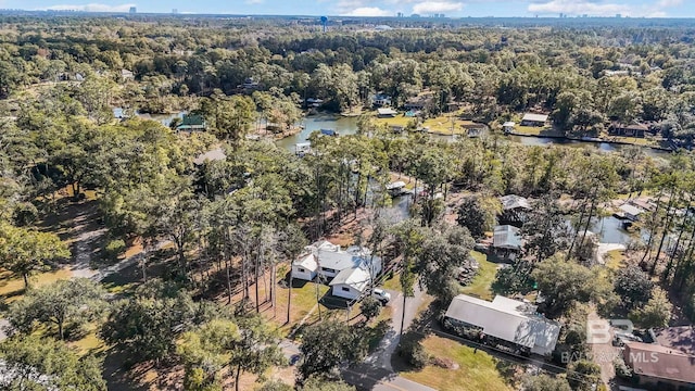 drone / aerial view with a water view and a wooded view