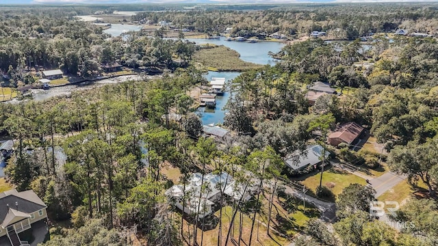 drone / aerial view featuring a forest view and a water view