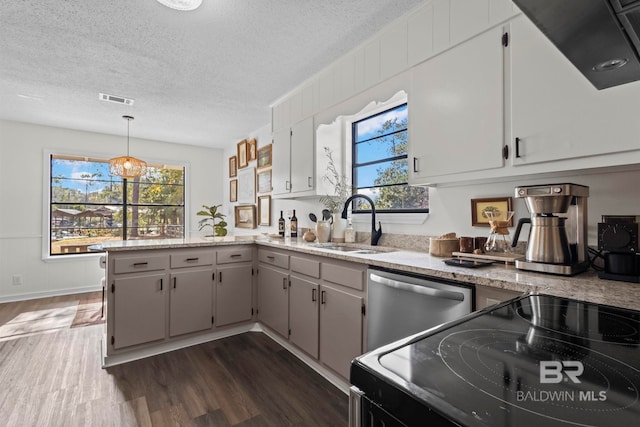 kitchen with visible vents, dishwasher, a peninsula, black / electric stove, and a sink