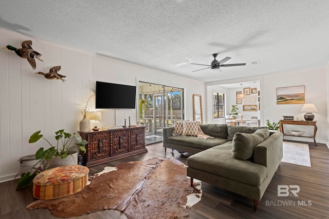 living room featuring visible vents, ceiling fan, a textured ceiling, and wood finished floors