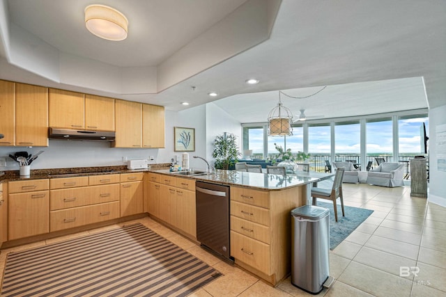 kitchen with stainless steel dishwasher, kitchen peninsula, sink, and light brown cabinets